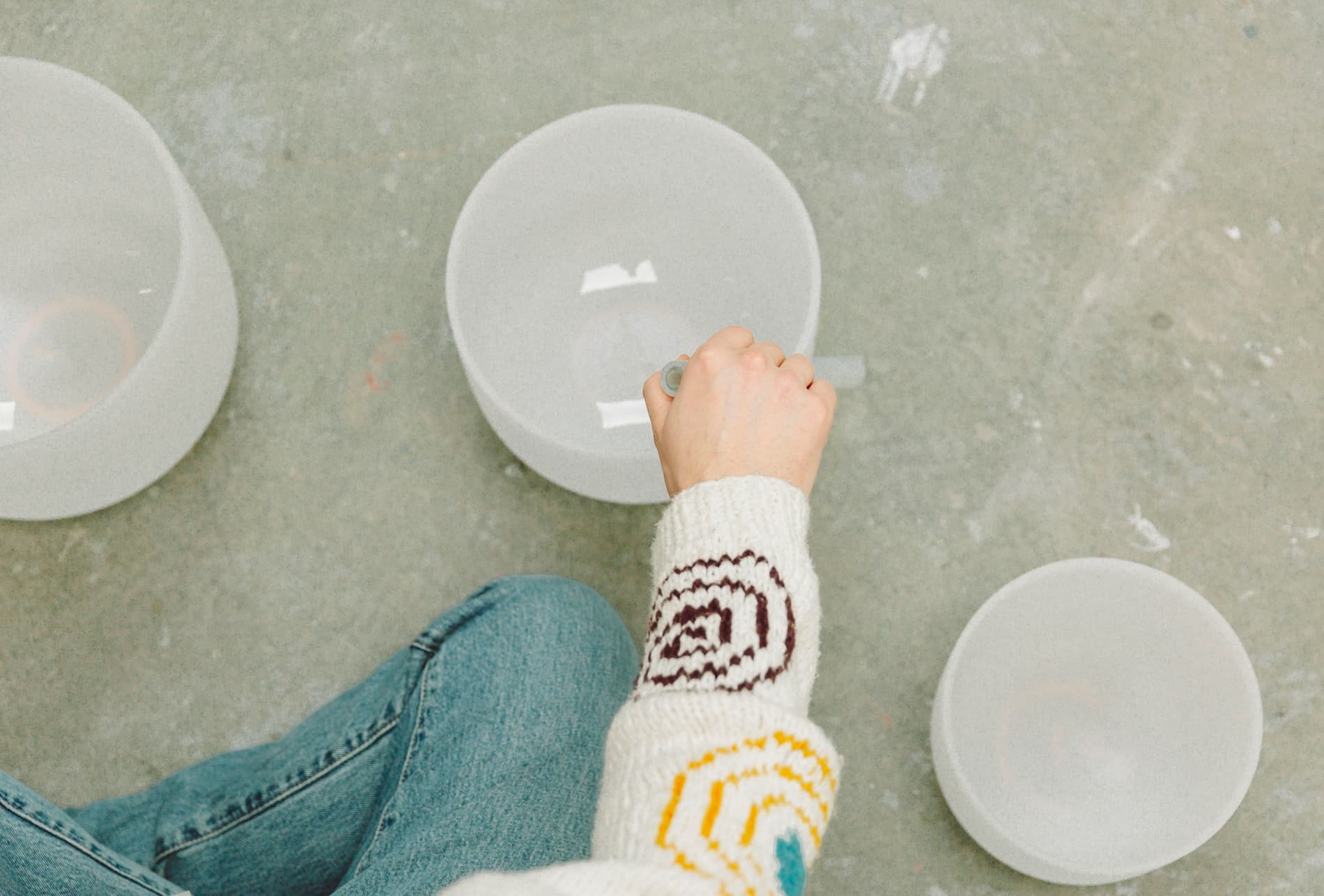 Crystal singing bowls being played